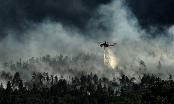 A helicopter drops water on the Waldo Fire in Colorado on June 27, 2012.