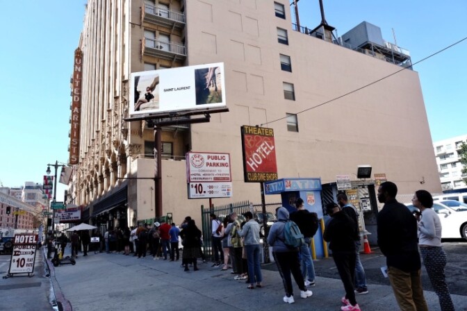 Voters hoping to cast their ballot at the Ace Hotel voting center in downtown Los Angeles braved long lines, with some people reportedly waiting up to two hours to vote on Tuesday, Mar. 3, 2020. | Chava Sanchez/LAist