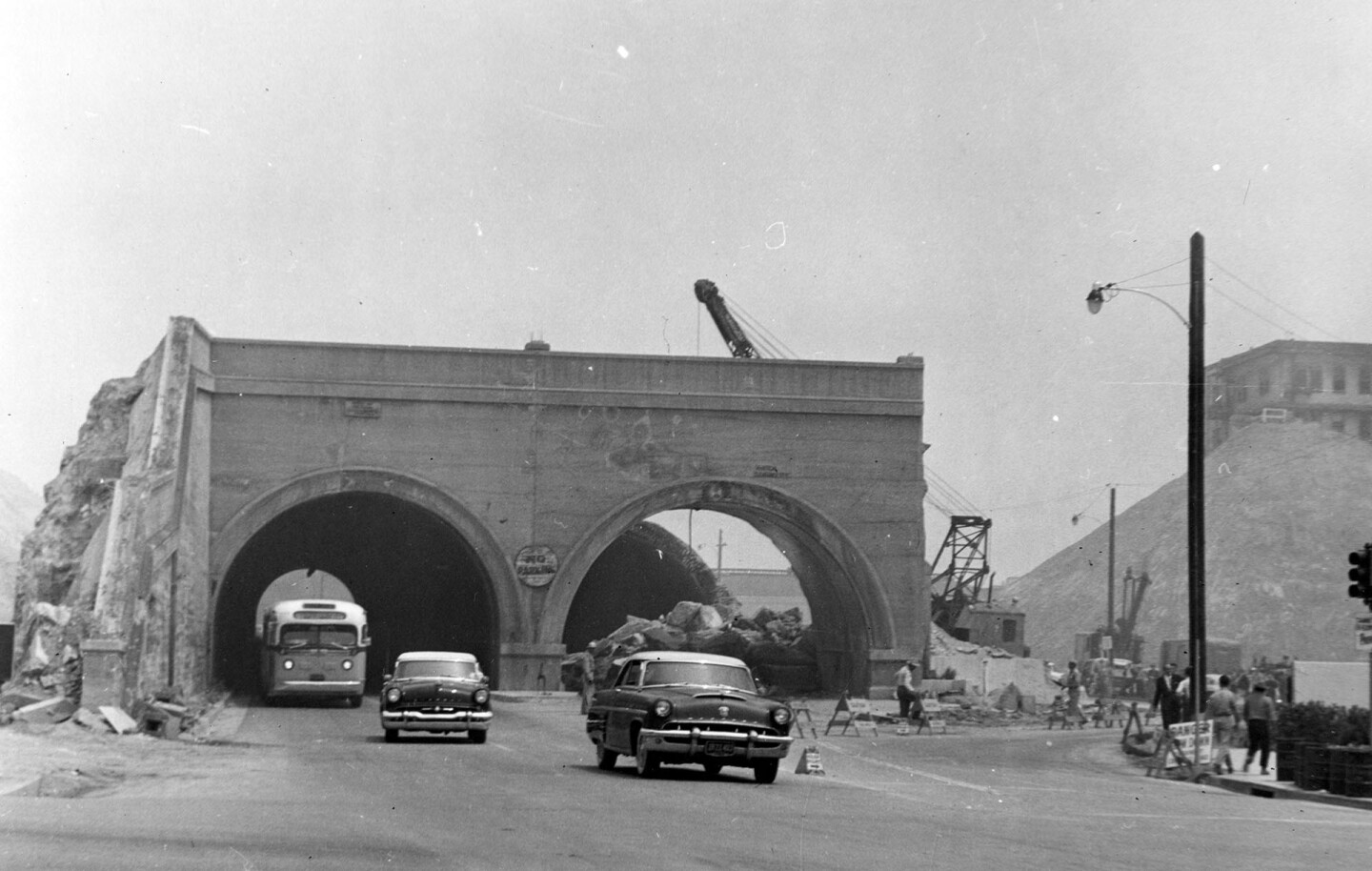 Road cuts and hill regrading transformed several of downtown Los Angeles' tunnels, like the Hill Street Tunnels, shown here at 1st Street in 1955, into mere arches. Courtesy of the Photo Collection - Los Angeles Public Library.