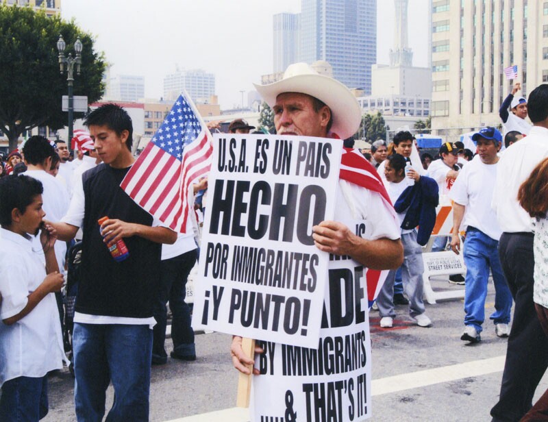 Day Without an Immigrant protester holds signs in English & Spanish that read: "U.S.A. is MADE by immigrants... & that's it!" Photo is courtesy of the LAPL.