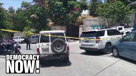 Vehicles parked haphazardly on a Haitian street barred by yellow caution tape.