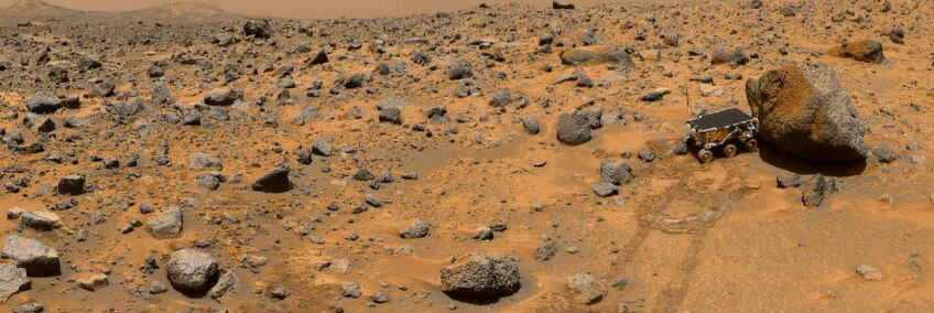 This portion of a classic 1997 panorama from the IMP camera on the mast of NASA's Mars Pathfinder lander includes "Twin Peaks" on the horizon, and the Sojourner rover next to a rock called "Yogi." | NASA/JPL