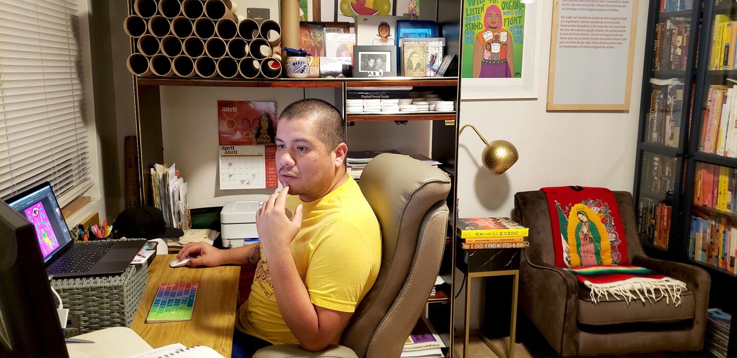 Julio Salgado works on a laptop at a desk.
