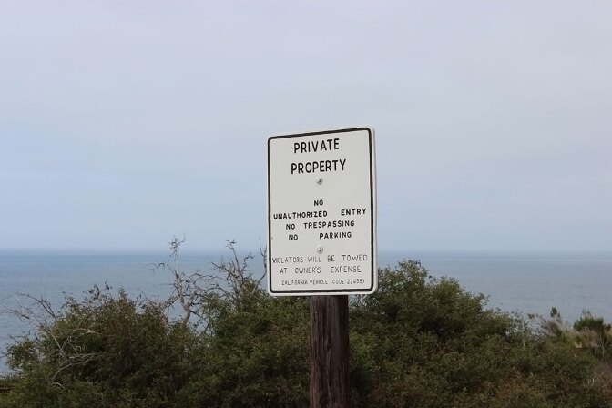 Private property sign overlooking ocean. | Spencer Robins