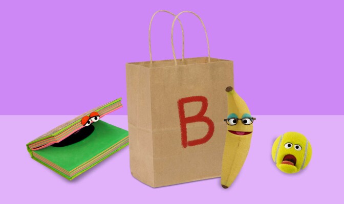 A brown paper bag with the letter B on it next to a notebook, banana and ball with cartoon eyes.