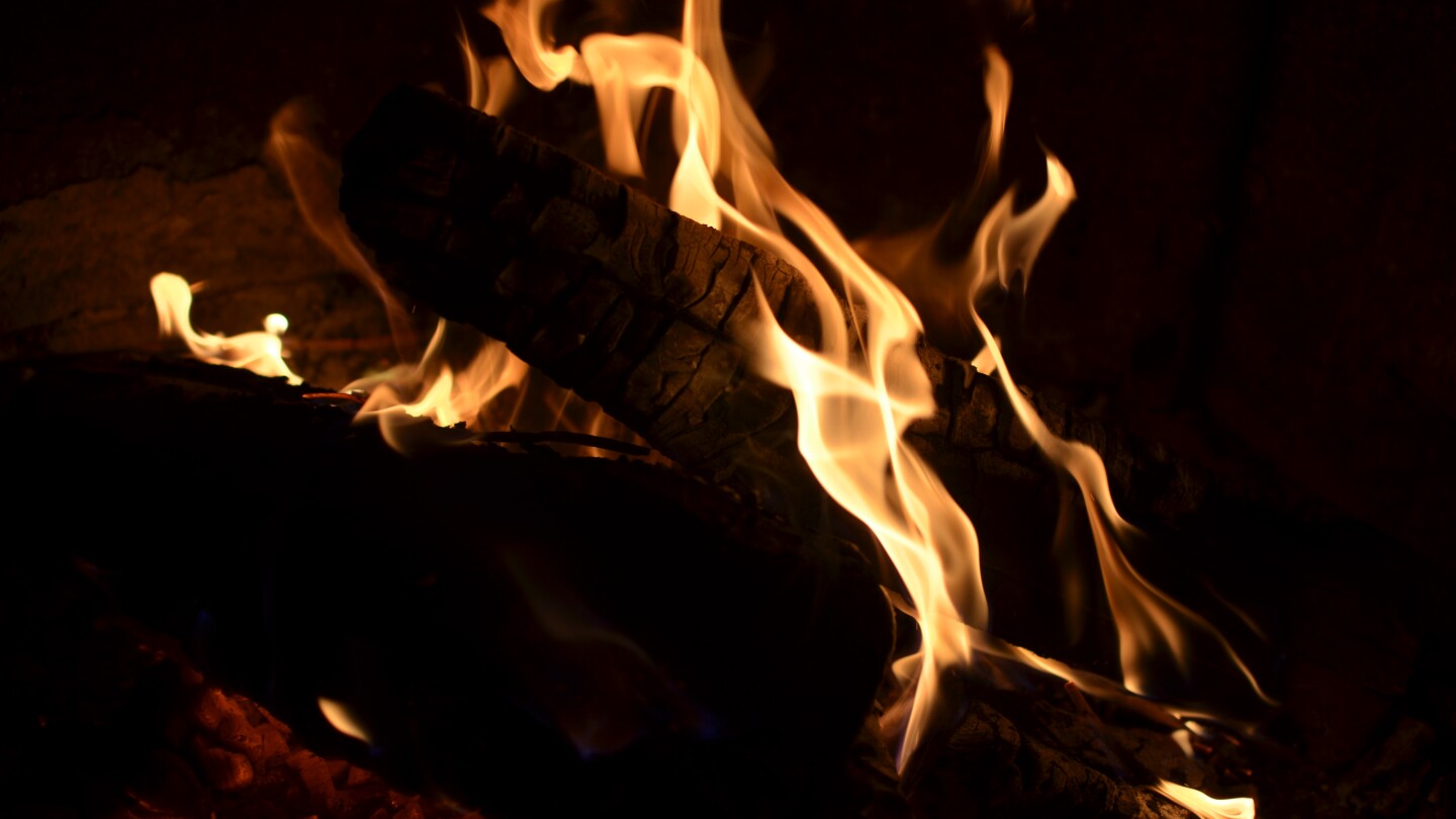 Fire burns on campfire logs