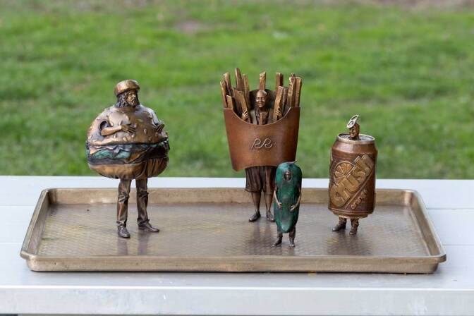 Uneaten Lunch consists of a hamburger, a pack of French fries, a soda can and a pickle cast in bronze. They will be available for viewing until Nov. 3 at Palms Park, Tuesday, Oct. 1, 2019. | AP Photo/Ry Rocklen