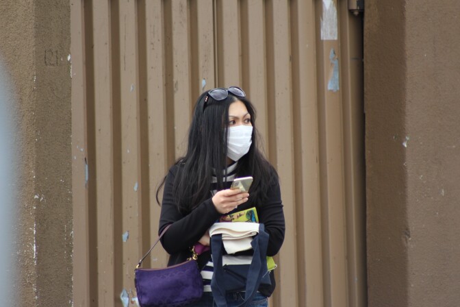 Woman looks to her left wearing a face mask | Karen Foshay