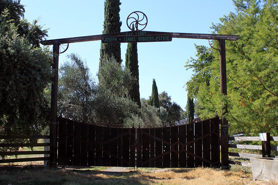 Outdoor Wooden Gate Reading "Est. 1889 - Joseph + Isabel Rodgers Estate"