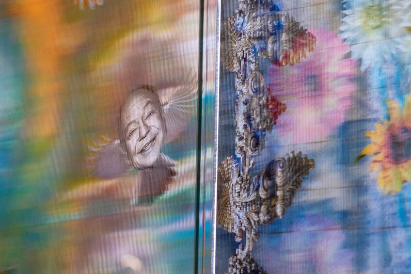 An image of Cheech Marin with wings is part of an large piece of artwork.
