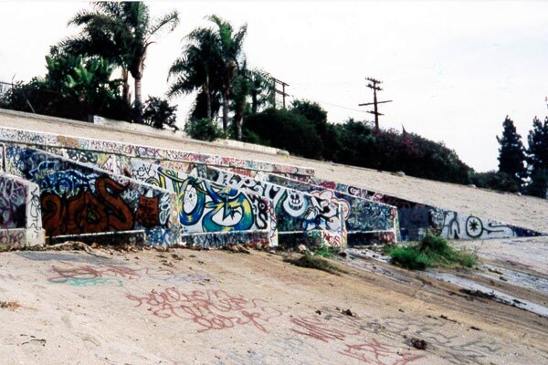 Concrete flood-control structures also serve as canvases for young and veteran graffiti artists. 1999 I Photo by Juan Devis