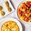 Three dishes served Dolan's in Alhambra are goshnaan, a meat pie; manta, a steamed dumpling and big plate chicken, a kind of chicken stew served noodles.