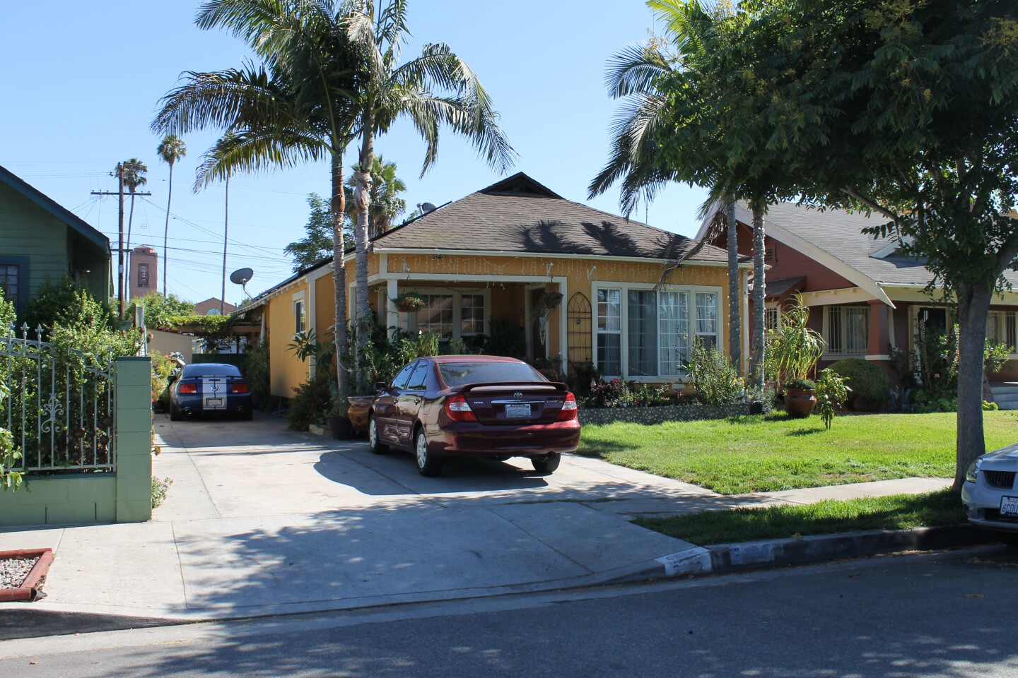 A yellow home with two cars parked in the driveway. It is the garage where "Earth Angel" was recorded.