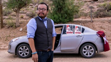 Moroni Benally waits to greet voters arriving at the polling station in Sweetwater, Arizona, on August 26, 2014. | From "America ReFramed: Moroni for President"