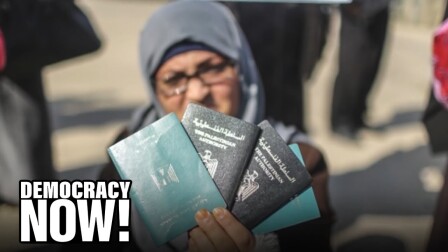 A person holds up Palestinian Authority passports.