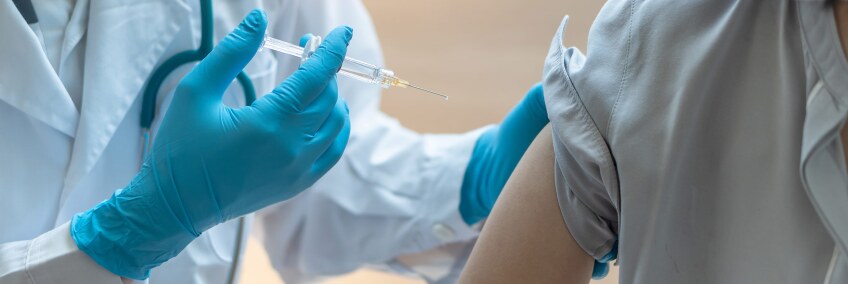 A health worker vaccinates a person. | iStock / Getty Images