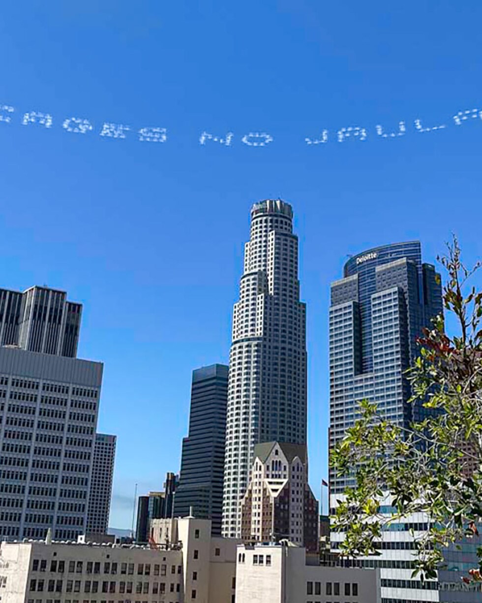 "NO CAGES, NO JAULAS" written in in the sky, contributed by Beatriz Cortez, over the Immigration Court on Olive Street | Dee Gonzalez, In Plain Sight