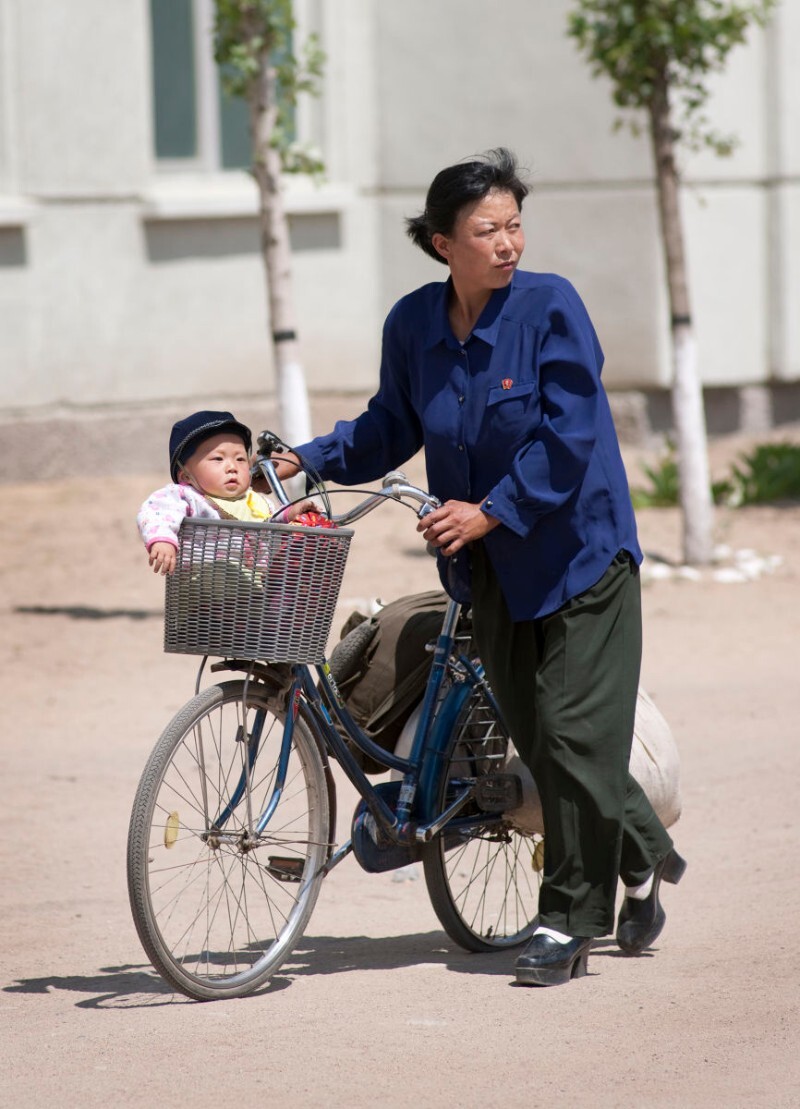 Mother and child in front of the Tumangang train station in North Korea | Mark Edward Harris/Getty Images