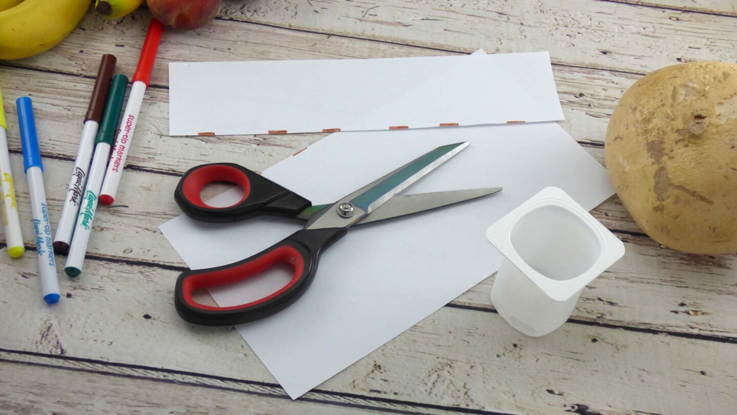 Cut strips of paper for treasure chest.