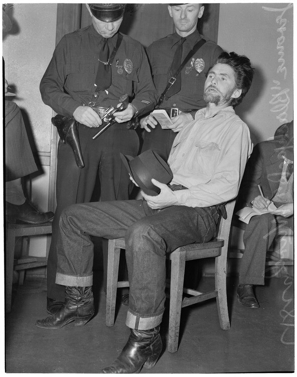 Cowboy film extra Jerome "Blackjack" Ward talks to police during a re-enactment of his confrontation with fellow extra Johnny Tyke, Los Angeles, February 24, 1940