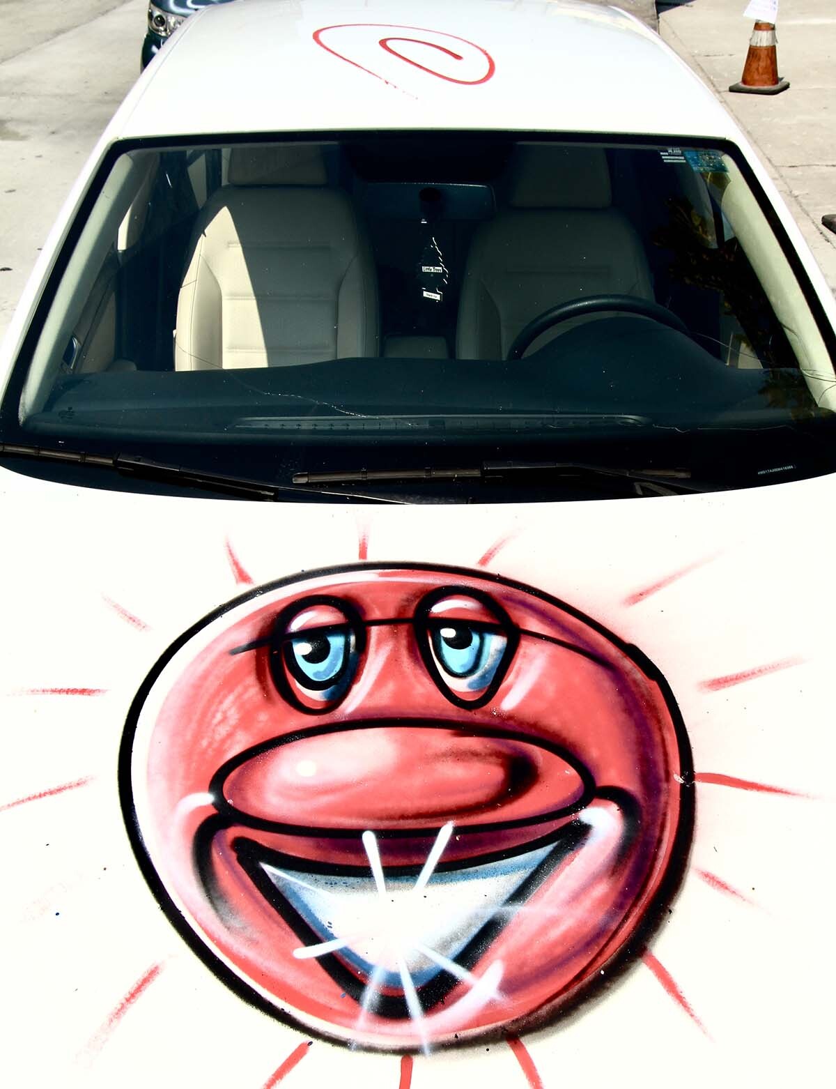 The hood of a white car participating at Kenny Scharf's "Karbombz!" car parade September 26, 2020 | Jordan Riefe
