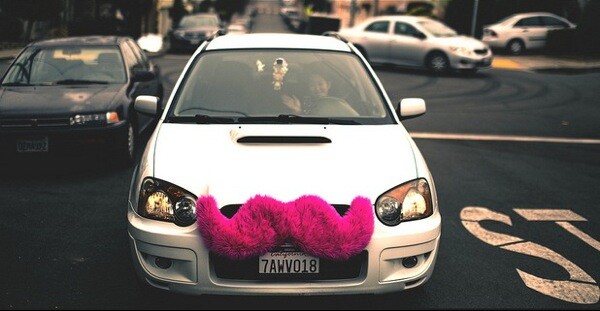 A Lyft driver waves for the camera.