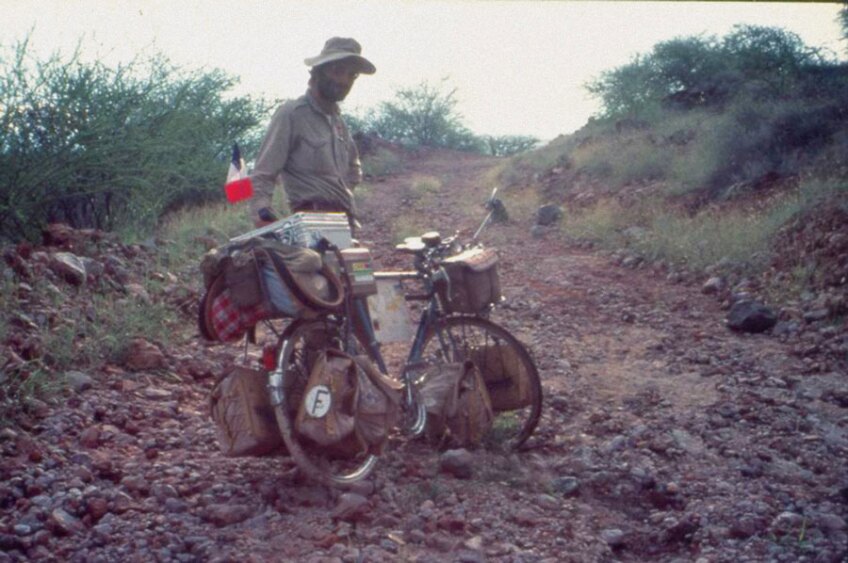 Jöel Lodé on a rocky road in Kenya while traversing the globe on bicycle.