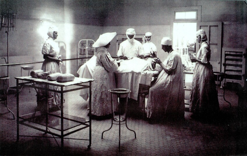 Operating room, Los Angeles Infirmary, 1908. The nurses and doctors are assisted by a sister wearing her wing-like wimple.