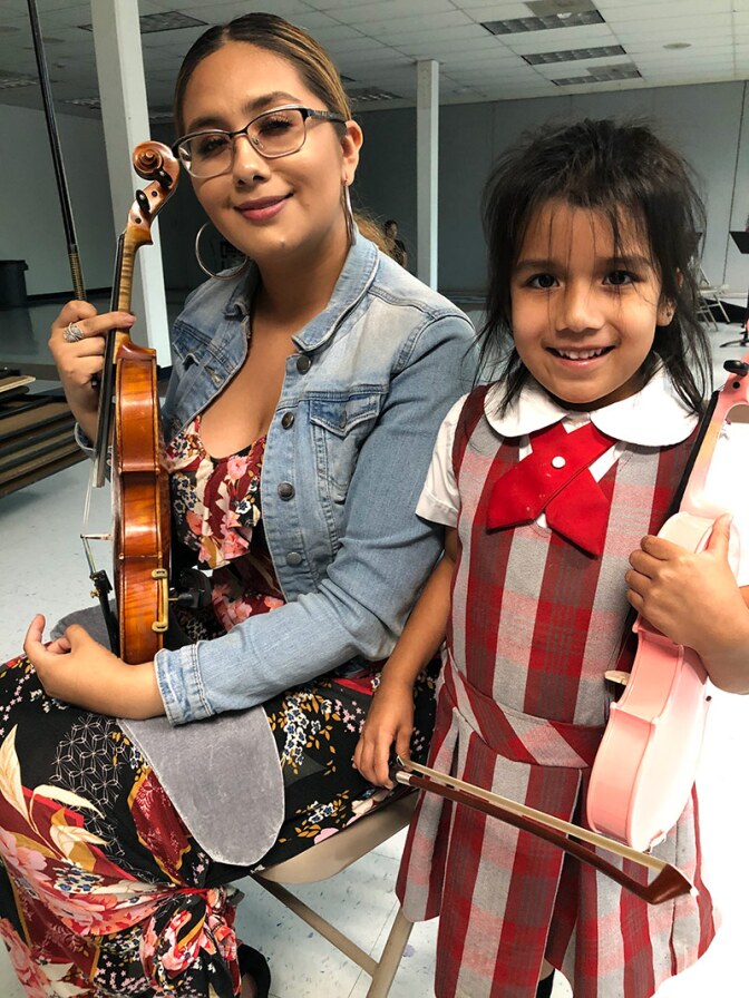 America Mata with a young student from her introduction to violin class. | Courtesy of Richard Mata