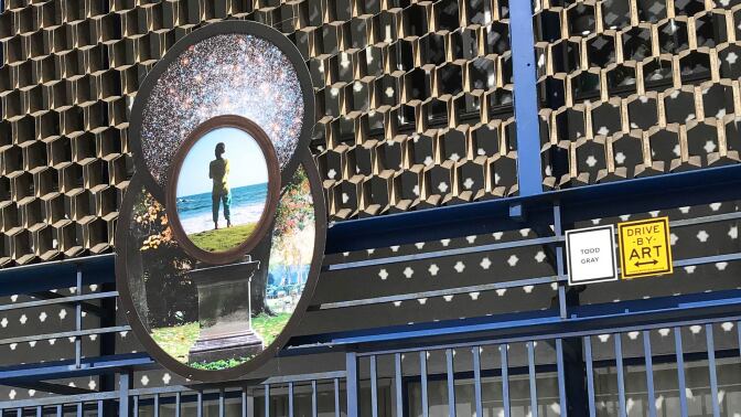 Todd Gray's juxtaposition of a dark-skinned boy atop a pedestal with the cosmos over his head on Crenshaw Boulevard in Leimert Park. | Carol Cheh