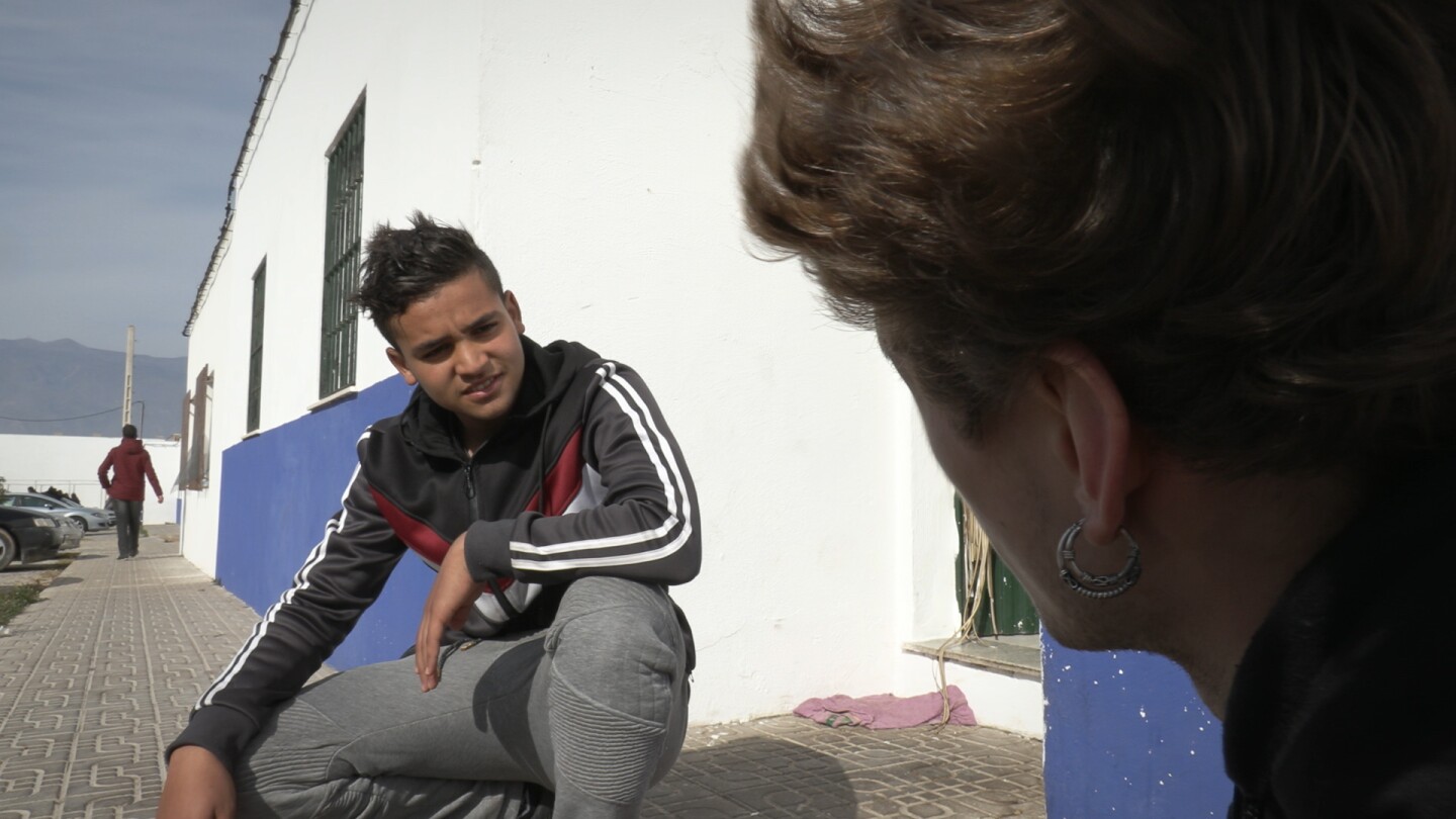 Abubaker, 17-year old migrant from Morocco, tells a Spanish teenager that he risked his life on a wooden boat across the Mediterranean Sea because there were no jobs at home.