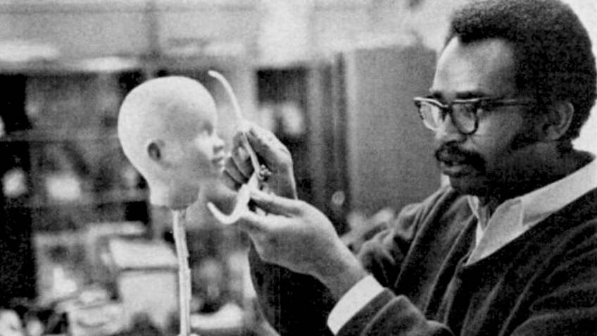 A man sculpting a Shindana Toy doll head from a Jet Magazine story published by Johnson Publishing Company | Still from "Lost LA" Shindana Toys