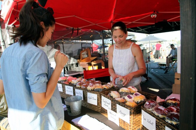 Chari Heredia-Reyes, owner of the Ensaymada Project, sells the brioche bread at the Orange County Night Market on June 16, 2017.
