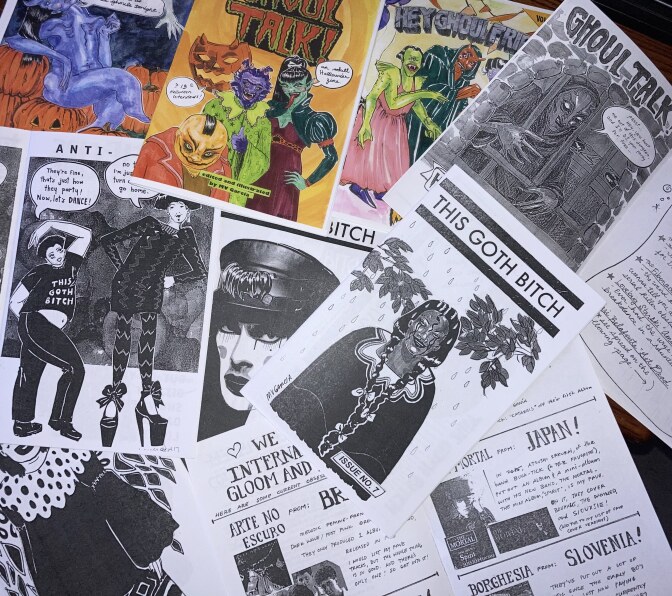 A pile of zines, small independently-published work. Most of the zines have Halloween and goth-themed artwork.