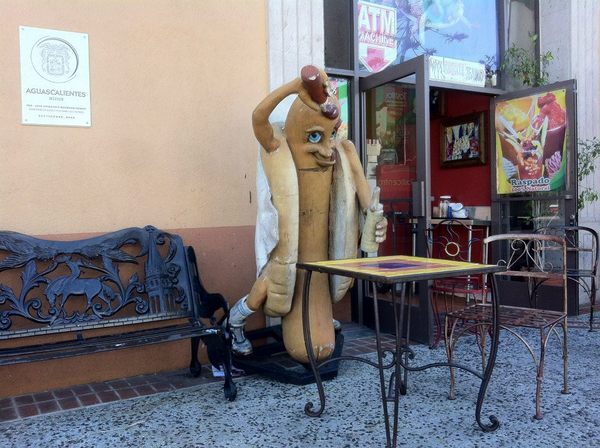 Mostly naked hot dog applying condiments
