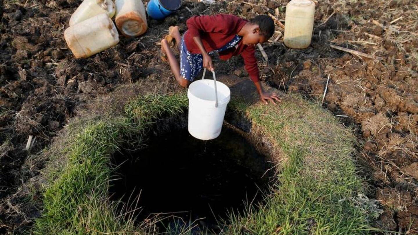 A woman fetches water from a well in Warren Park suburb, Harare, Zimbabwe, September 24, 2019. | REUTERS/Philimon Bulawayo