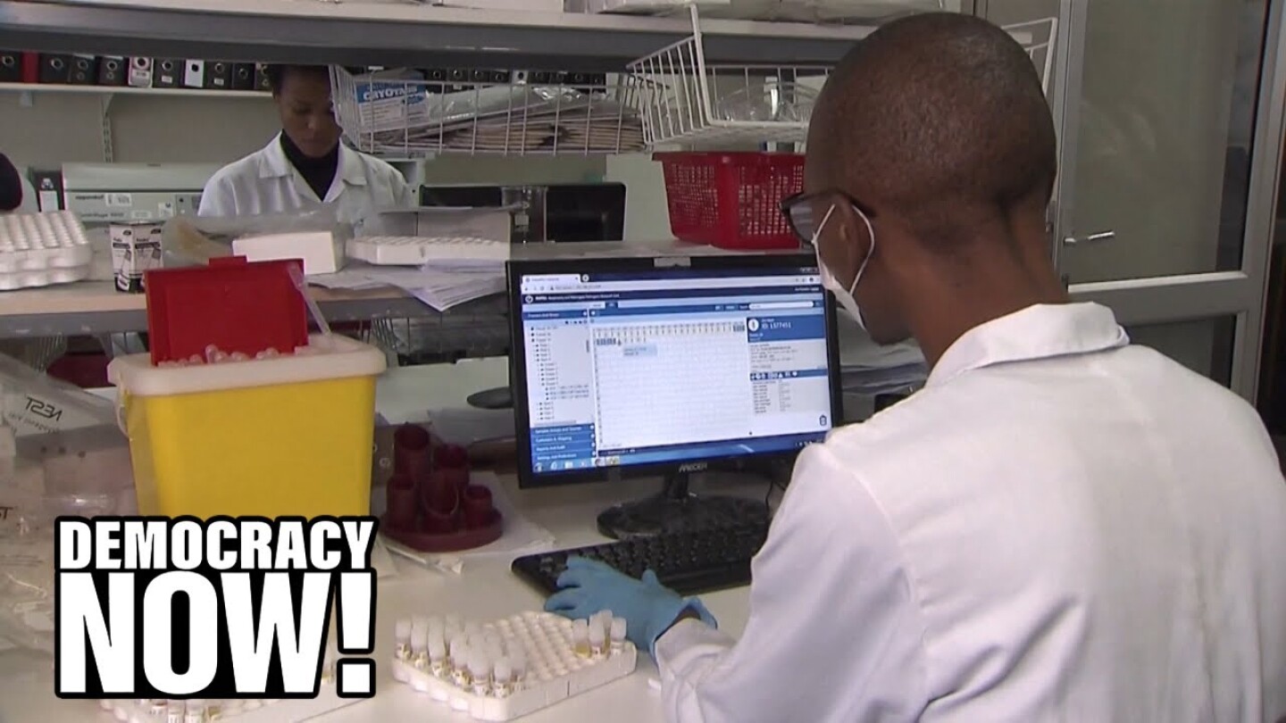 A lab worker at a computer.