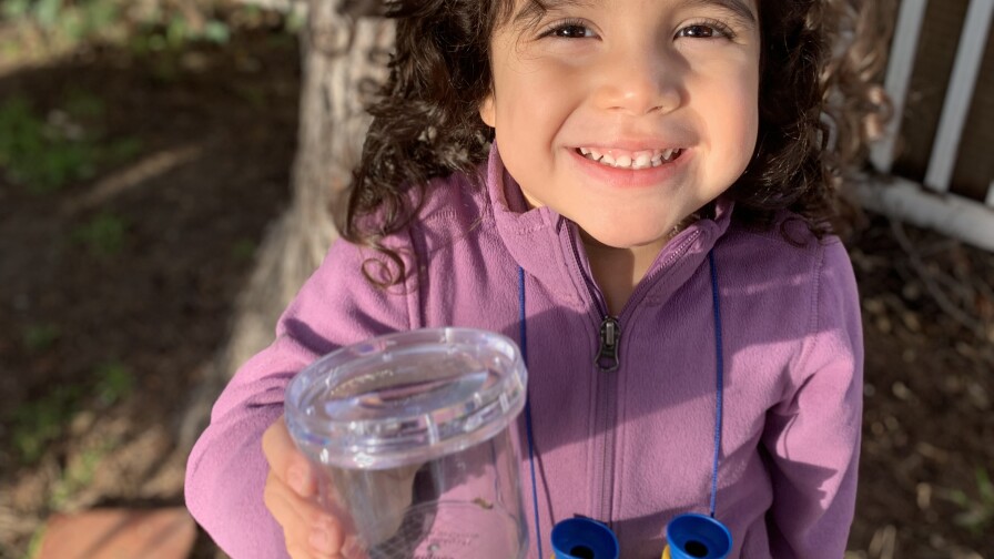 Miguel Ordeñana's daughter holding up a jar with an earthworm in it | Natural History Museum of Los Angeles County. Courtesy of Miguel Ordeñana
