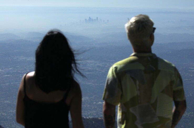 People take in the view with the buildings of downtown Los Angeles partially obscured at midday on November 5, 2019 as seen from Pasadena, California. | Mario Tama/Getty Images