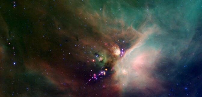 Newborn stars peek out from beneath their natal blanket of dust in this dynamic image of the Rho Ophiuchi dark cloud from NASA's Spitzer Space Telescope. | Flickr/NASA Marshall Space Flight Center/Creative Commons (CC BY-NC 2.0)