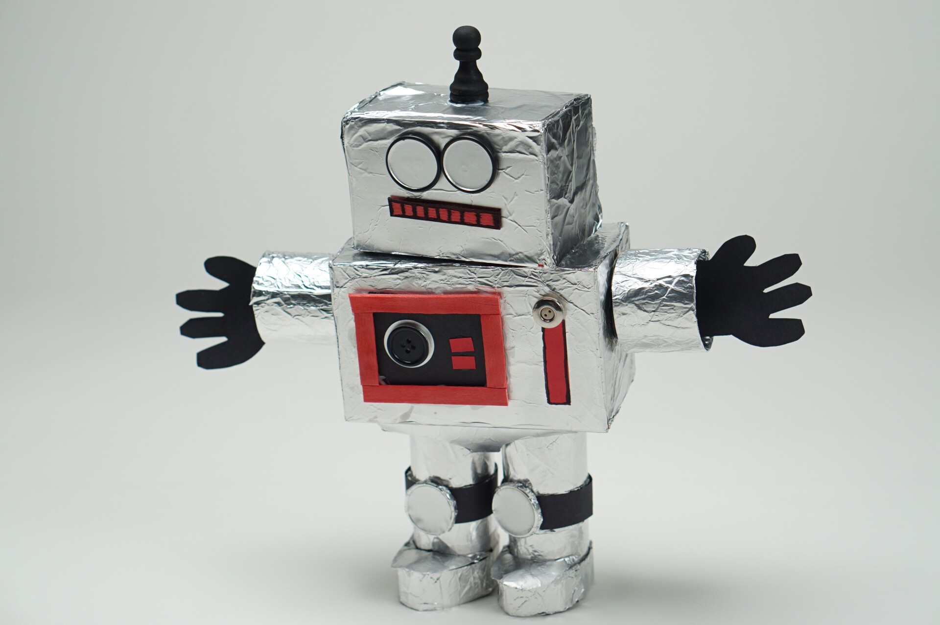 a  robot craft made out of boxes covered in aluminum foil decorated with various crafting materials