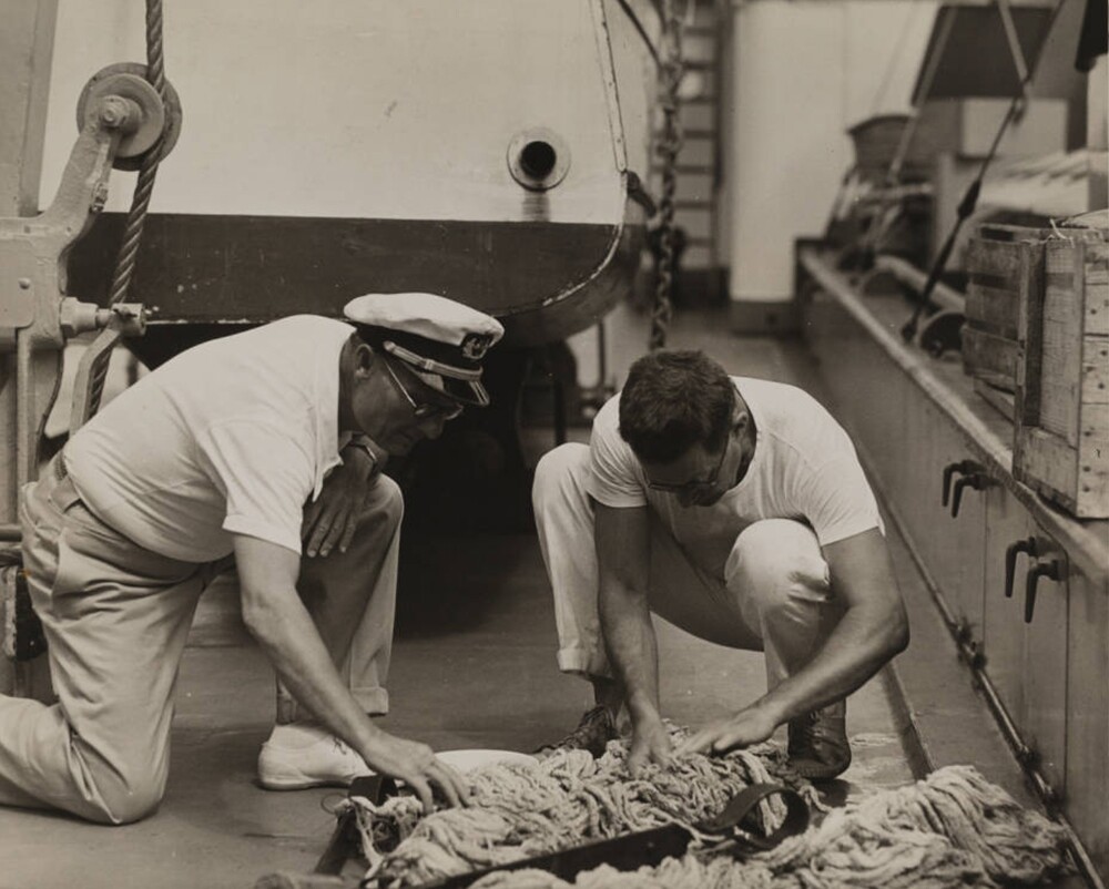 Captain Hancock & Dr. Schmitt on deck sorting a dredge haul, Velero III, 1933 | Allan Hancock Foundation Collection, USC Libraries
