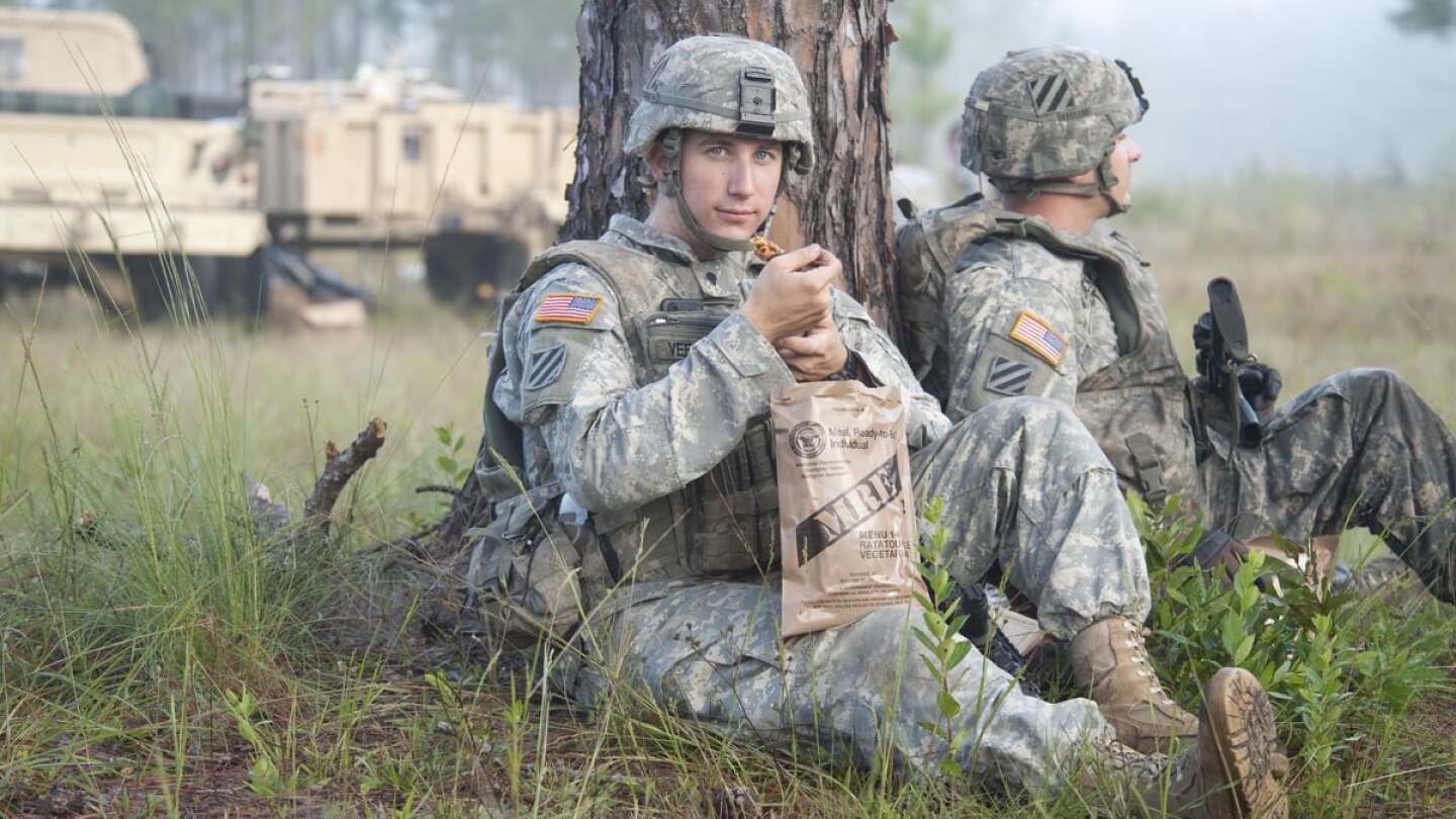 A still of soldier eating a Meals Ready to Eat (MRE) ration