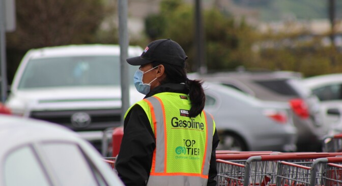 Costco worker in parking lot wearing face mask during COVID-19 pandemic cropped