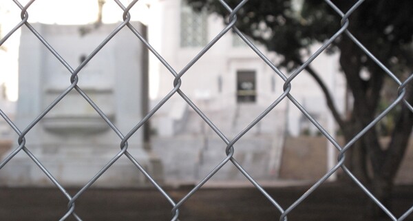 Looking through the gate at the former site of Occupy L.A. | Photo by Jason Rosencrantz