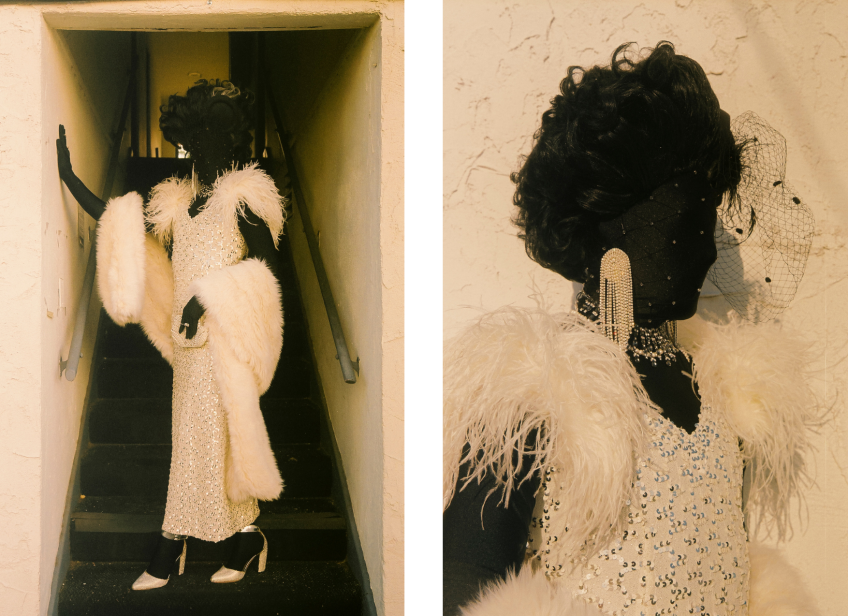 Two photos side by side. The photo on the left is a full body photo of Muxxxe, who is adorned in a sparkling white dress, curled wig and bedazzled jewelry over a morph suit, standing at the bottom of a staircase. The photo on the right is Muxxxe in the same clothing standing in front of a white wall.