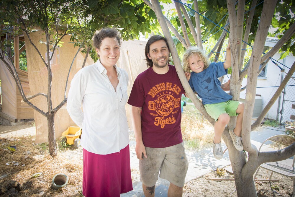 Christine, William, and Moses Mills in their yard.