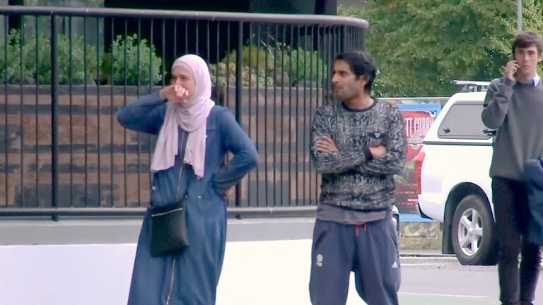 Woman overcome with emotion at scene of New Zealand shooting. | Still from "Democracy Now!"