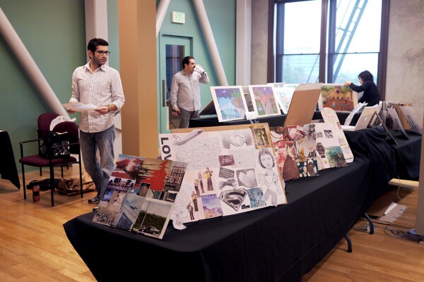 Teaching artists and coordinators set up the students' work at La Plaza de Cultura y Artes