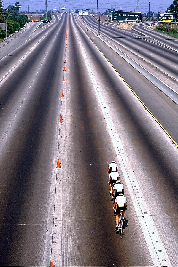 Road cycling team trail on the Artesia (91) Freeway. Courtesy of the LA84 Foundation.